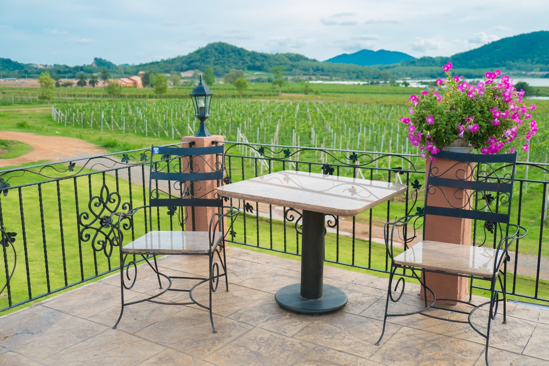 The corner of an outdoor patio overlooking a vineyard
